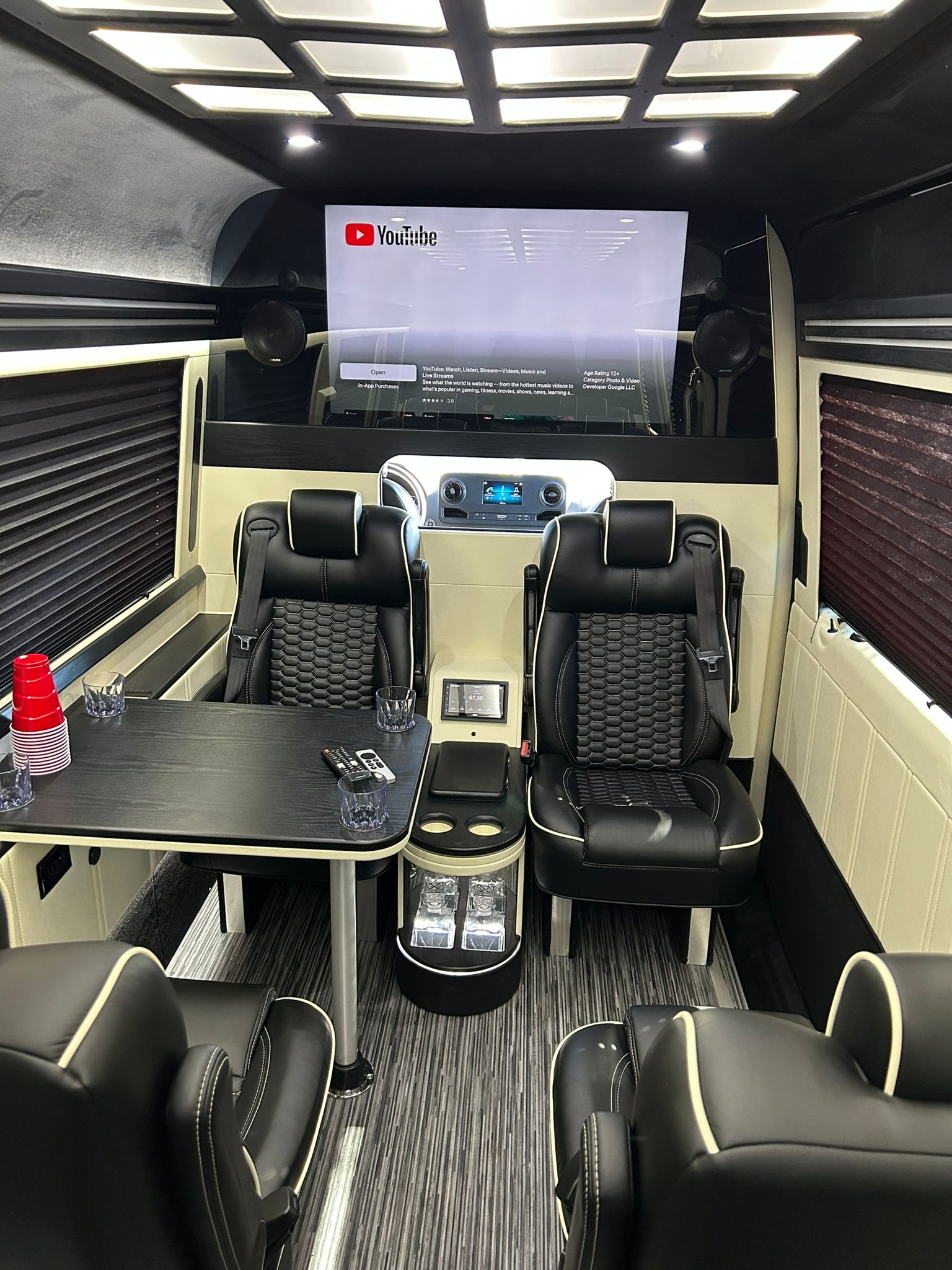 Executive Sprinter interior with lounge seating and media screen