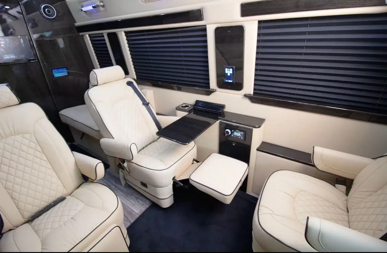 Cream executive Sprinter interior with lounge-style seating