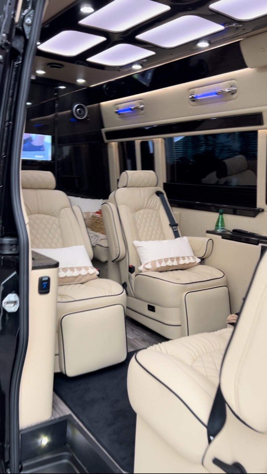 Cream Mercedes-Benz Sprinter interior with captain chairs