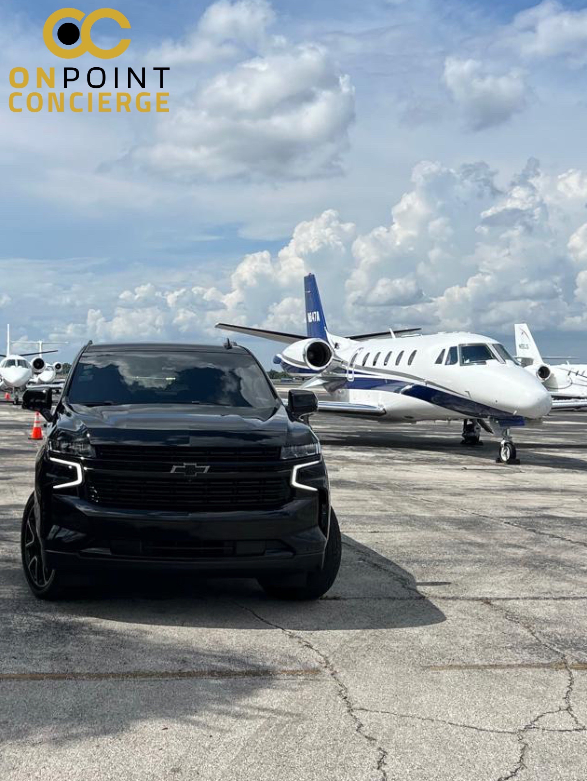 Black luxury SUV with private jet behind it